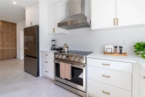 a kitchen with stainless steel appliances white cabinets and a stove