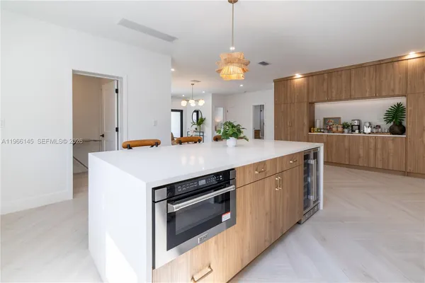 a kitchen with a sink a stove and cabinets