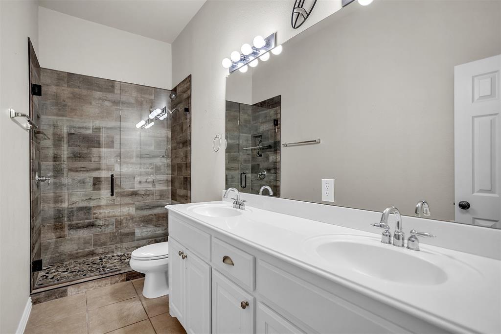 12286 Emerald Ranch Lane North Forney, TX 75126 - Photo 26 of 40 a bathroom with a double vanity sink mirror and shower