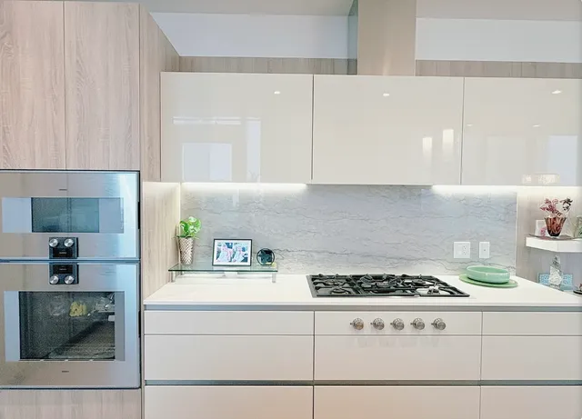 a kitchen with a stove and white cabinets