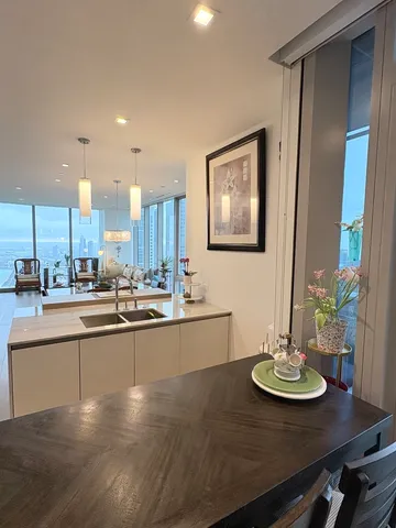 a view of a dining room with furniture and chandelier