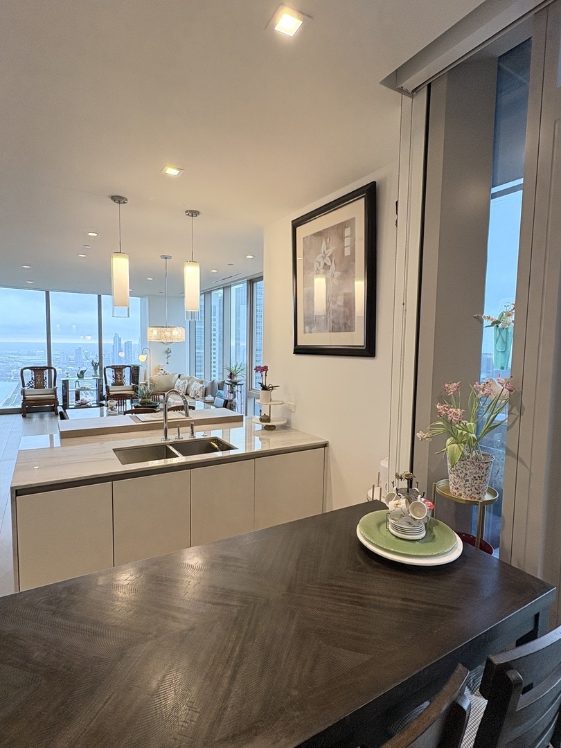 363 East Wacker Drive, Unit 4801 Chicago, IL 60601 - Photo 13 of 36 a view of a dining room with furniture and chandelier