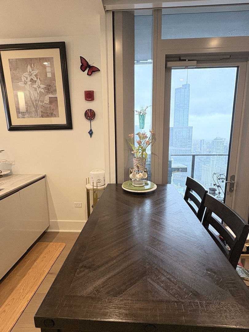 363 East Wacker Drive, Unit 4801 Chicago, IL 60601 - Photo 14 of 36 a view of a living room and dining room with wooden floor