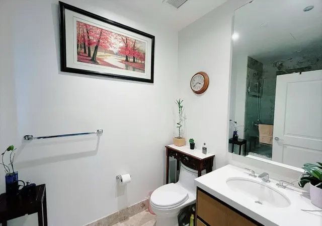 a bathroom with a toilet sink and mirror