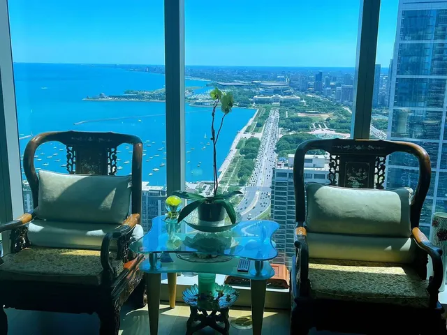a view of balcony with two chairs and a potted plant