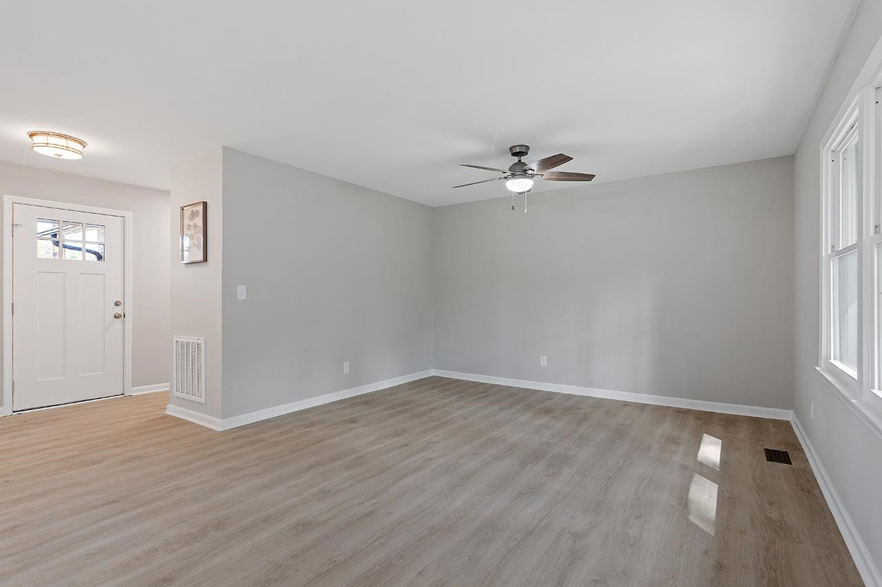 3420 Blue Ridge Road Raleigh, NC 27607 - Photo 17 of 36 wooden floor in an empty room with a window