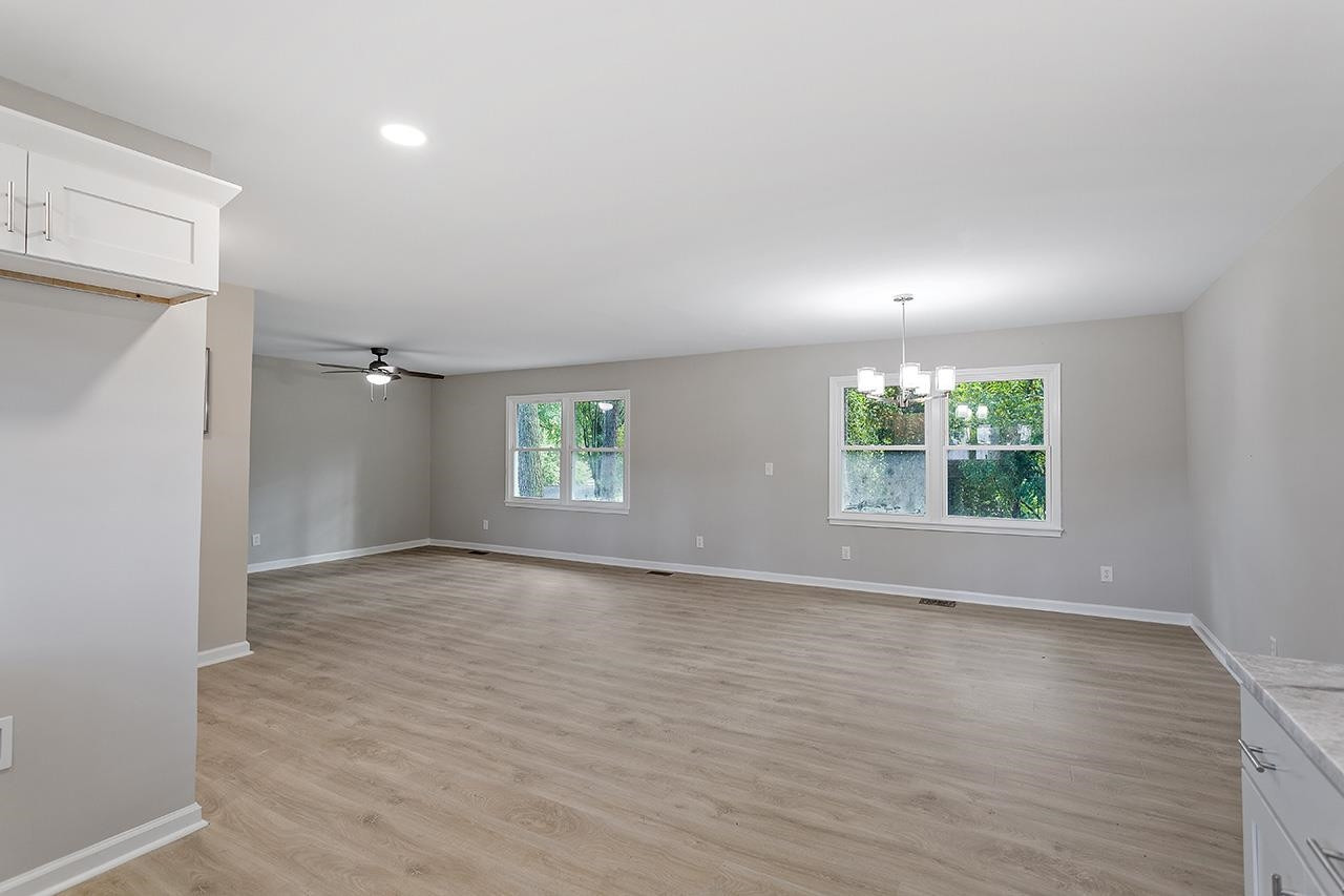 3420 Blue Ridge Road Raleigh, NC 27607 - Photo 18 of 36 an empty room with wooden floor and windows