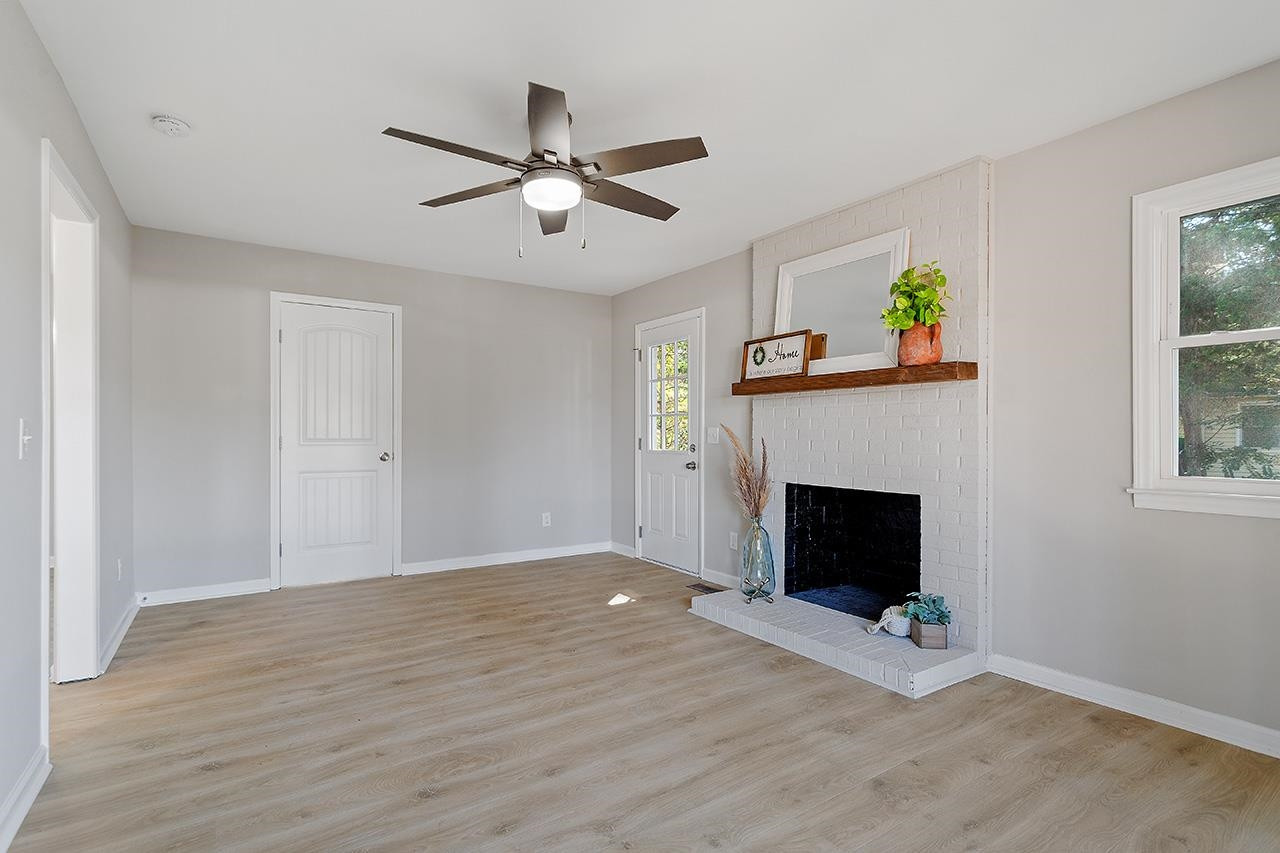 3420 Blue Ridge Road Raleigh, NC 27607 - Photo 21 of 36 a view of an empty room with a fireplace and a window