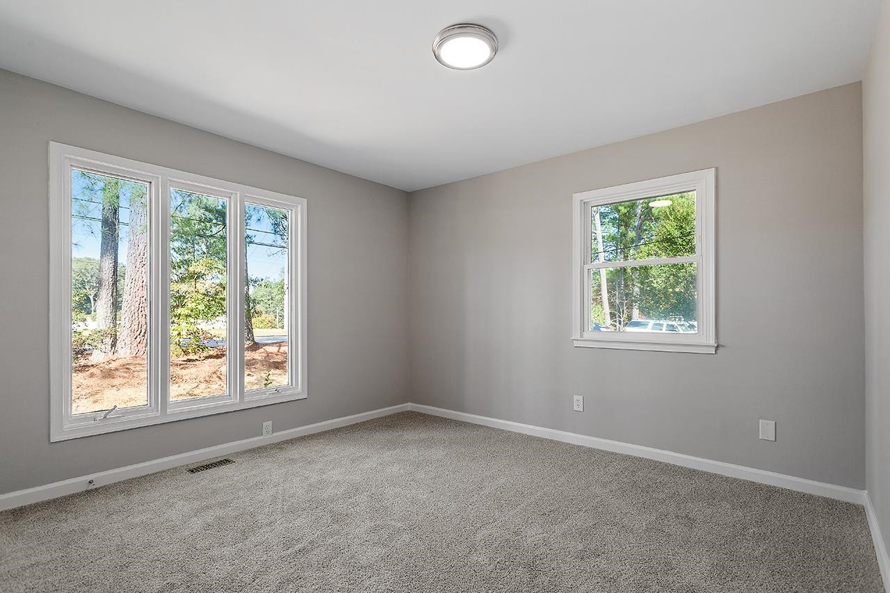 3420 Blue Ridge Road Raleigh, NC 27607 - Photo 22 of 36 wooden floor and window in an empty room