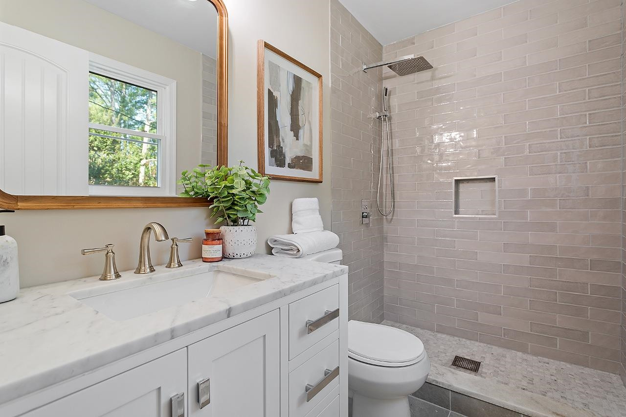 3420 Blue Ridge Road Raleigh, NC 27607 - Photo 28 of 36 a bathroom with a granite countertop sink a toilet and a mirror