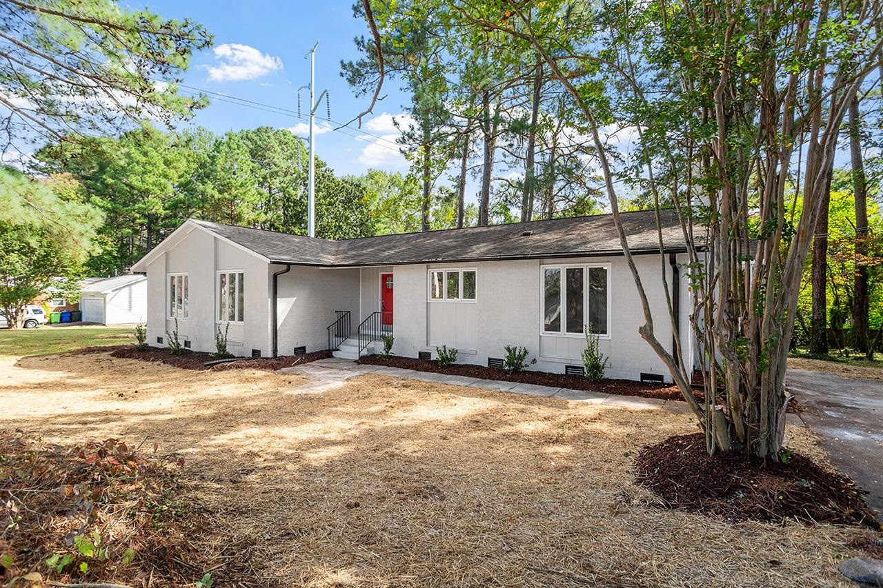3420 Blue Ridge Road Raleigh, NC 27607 - Photo 31 of 36 a view of a house with backyard and a tree