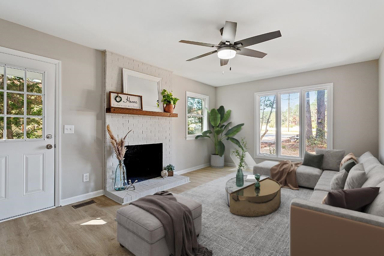 3420 Blue Ridge Road Raleigh, NC 27607 - Photo 5 of 36 a living room with furniture and a fireplace