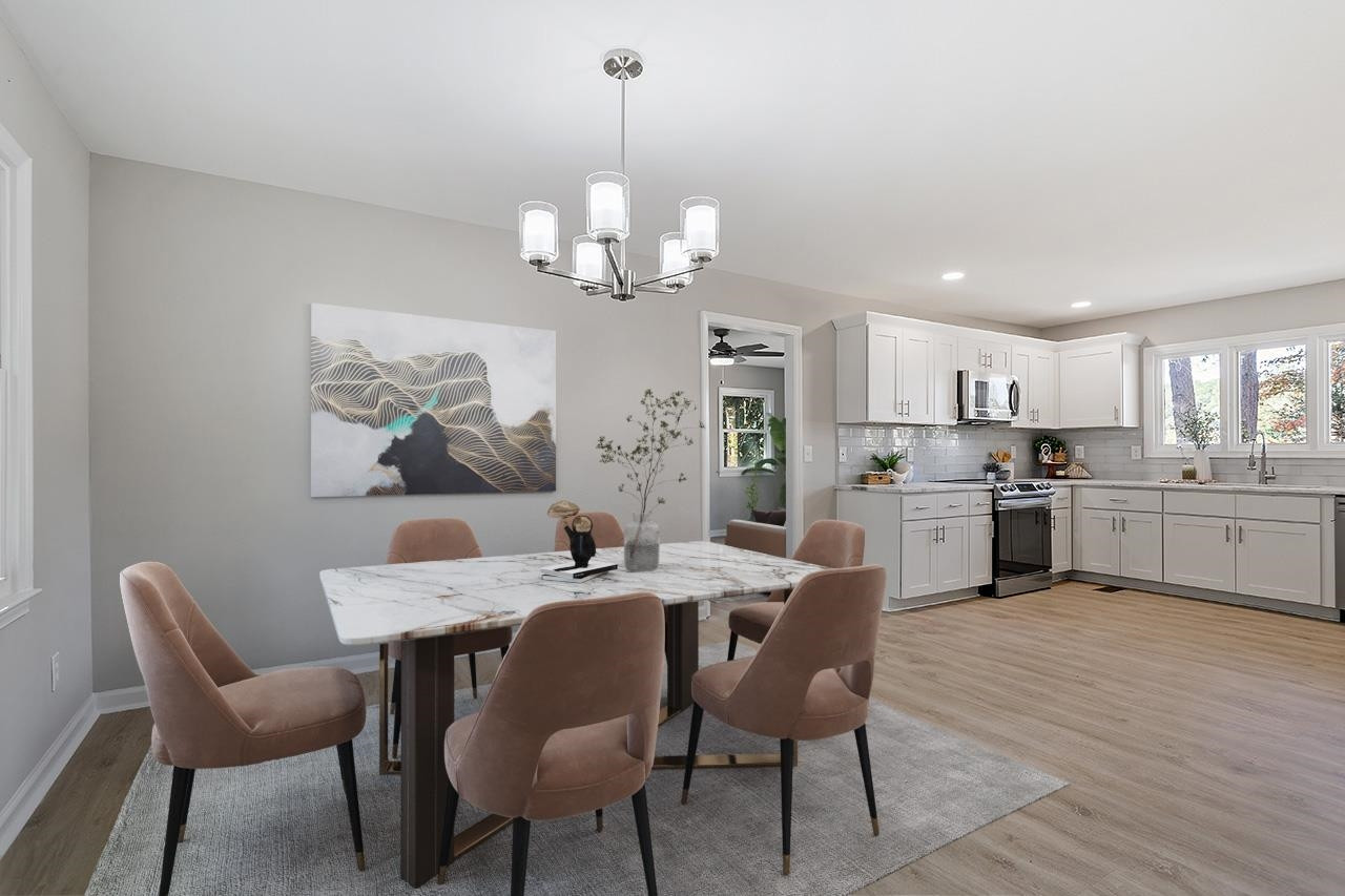 3420 Blue Ridge Road Raleigh, NC 27607 - Photo 6 of 36 a view of a dining room with furniture a chandelier and wooden floor