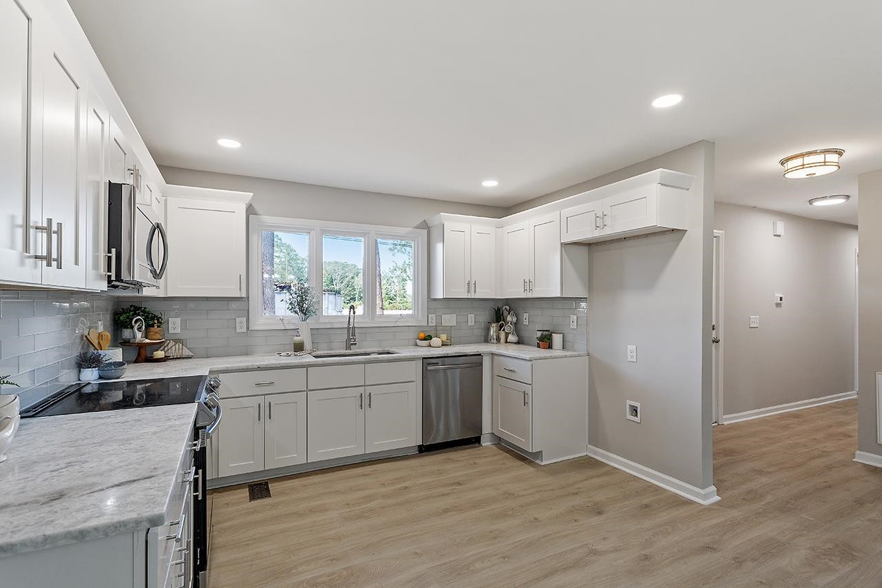 3420 Blue Ridge Road Raleigh, NC 27607 - Photo 9 of 36 a kitchen with stainless steel appliances granite countertop refrigerator sink and cabinets