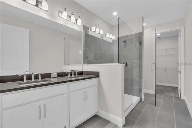 a bathroom with a double vanity sink mirror and double