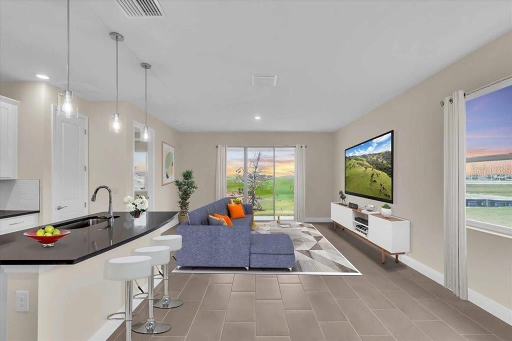 9258 Gulf Haven Drive Palmetto, FL 34221 - Photo 24 of 29 a living room with furniture and a flat screen tv