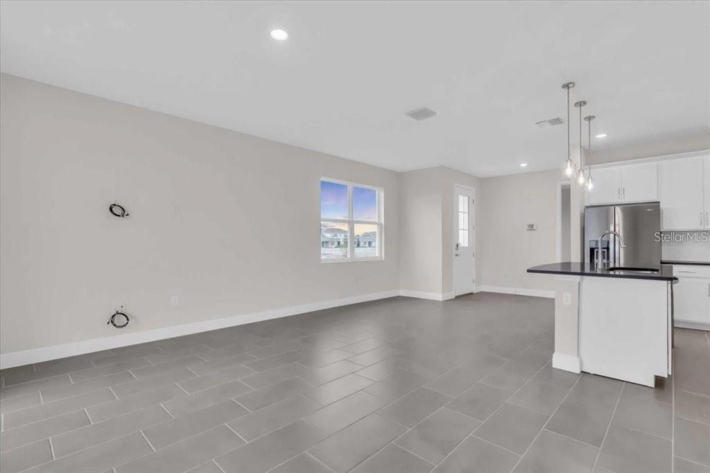 9258 Gulf Haven Drive Palmetto, FL 34221 - Photo 6 of 29 a view of an empty room with window and a kitchen view