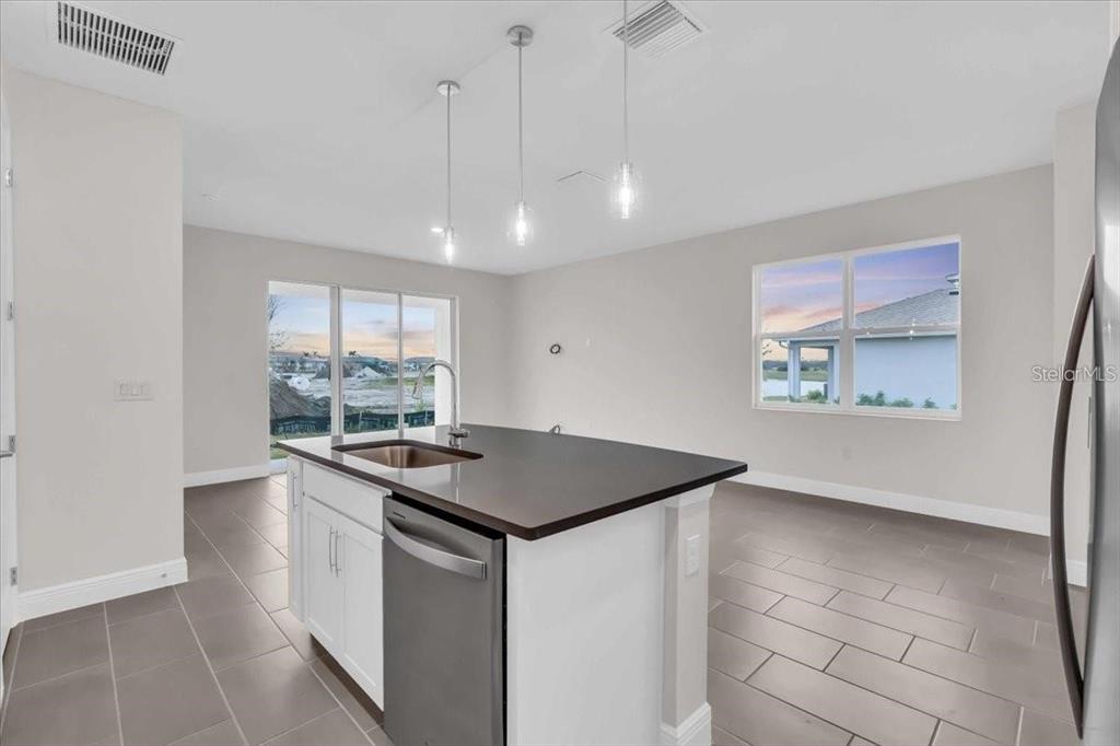 9258 Gulf Haven Drive Palmetto, FL 34221 - Photo 8 of 29 a kitchen with stainless steel appliances granite countertop a sink and a refrigerator