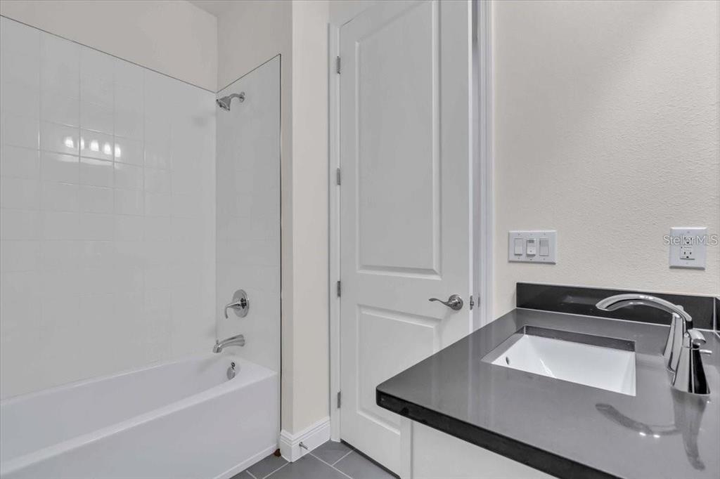 9258 Gulf Haven Drive Palmetto, FL 34221 - Photo 10 of 29 a bathroom with a bathtub and a sink