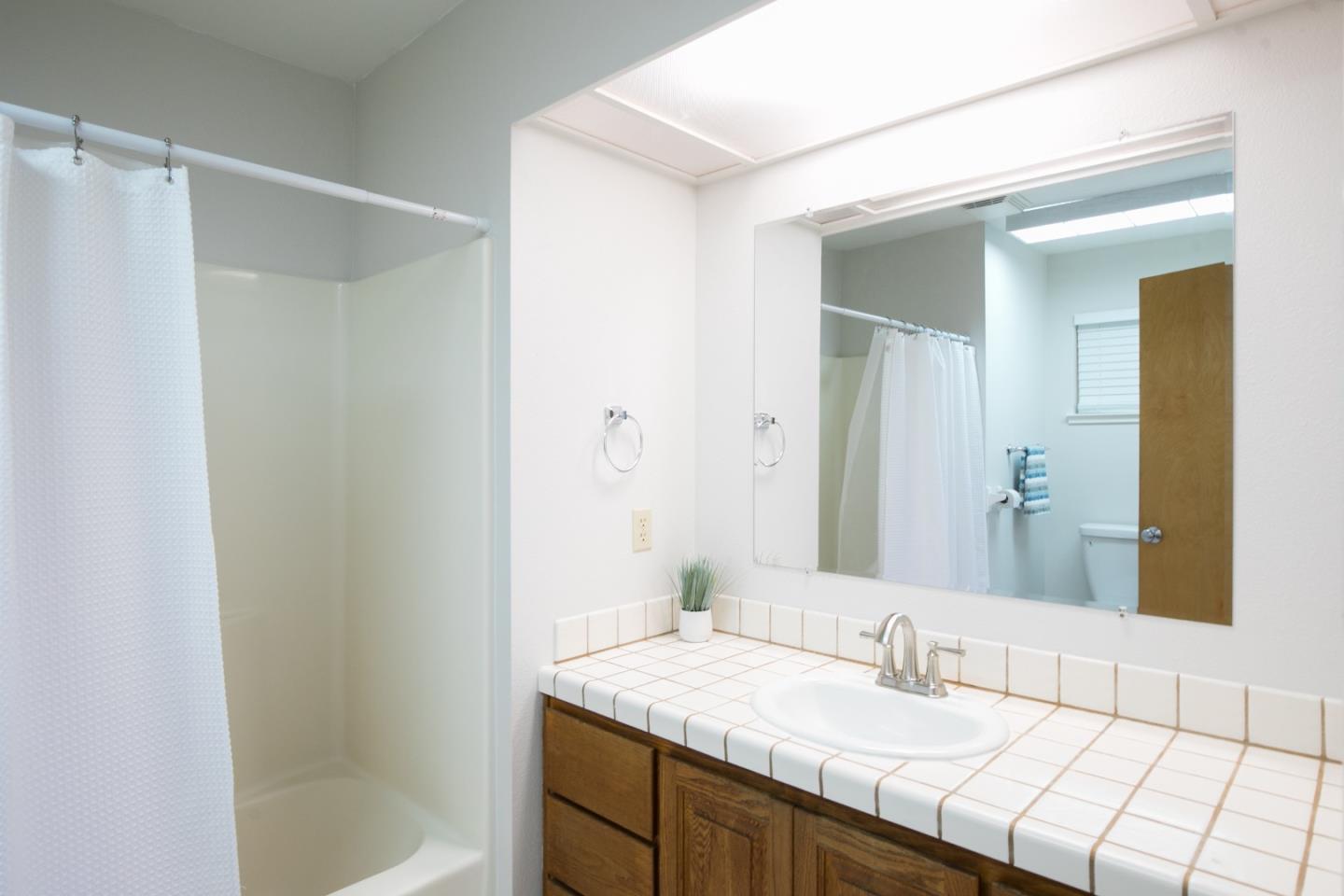 73 Webb Road Watsonville, CA 95076 - Photo 12 of 17 a bathroom with a granite countertop sink and a mirror