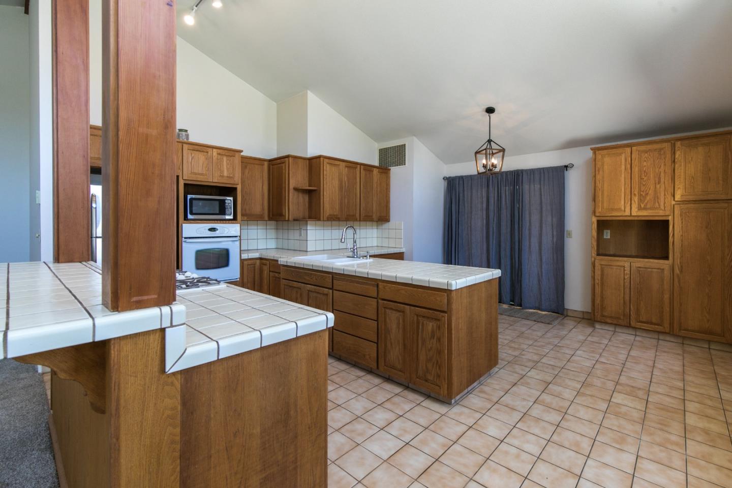 73 Webb Road Watsonville, CA 95076 - Photo 5 of 17 a kitchen with stainless steel appliances a stove a sink a microwave a refrigerator a counter top space and cabinets