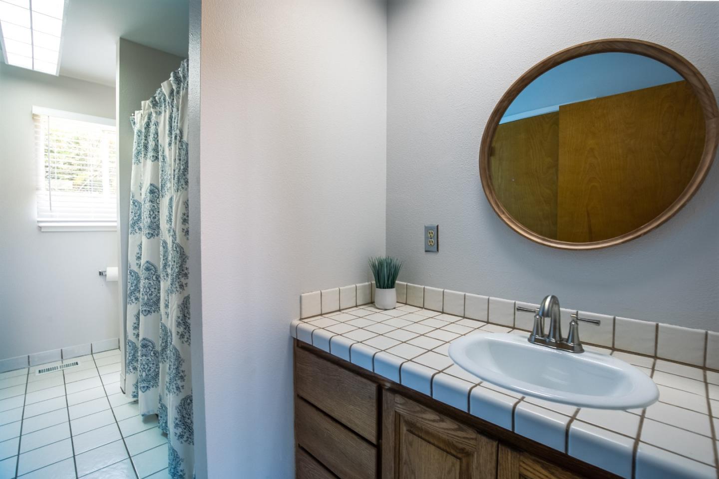 73 Webb Road Watsonville, CA 95076 - Photo 9 of 17 a bathroom with a granite countertop sink and a mirror