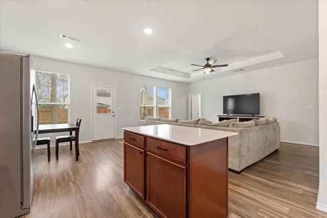 a view of a kitchen with a sink wooden floor and a window
