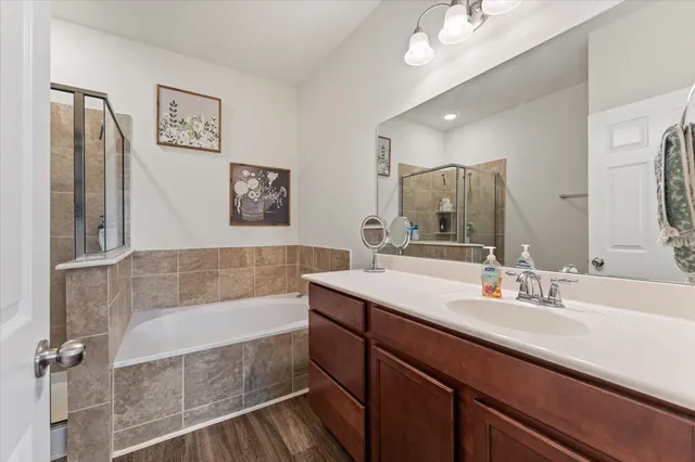 a bathroom with a tub a sink and mirror