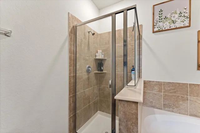 a bathroom with a shower and a sink