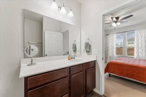 a en suite bathroom with a double vanity sink and a mirror