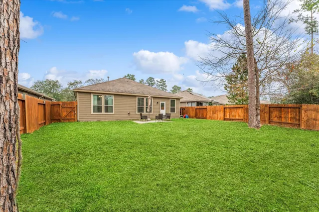 a front view of a house with yard and green space