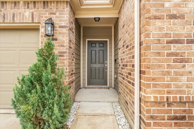 a view of a brick house with a large windows