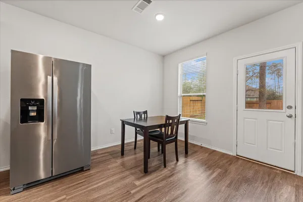 a view of a dining room with furniture and wooden floor