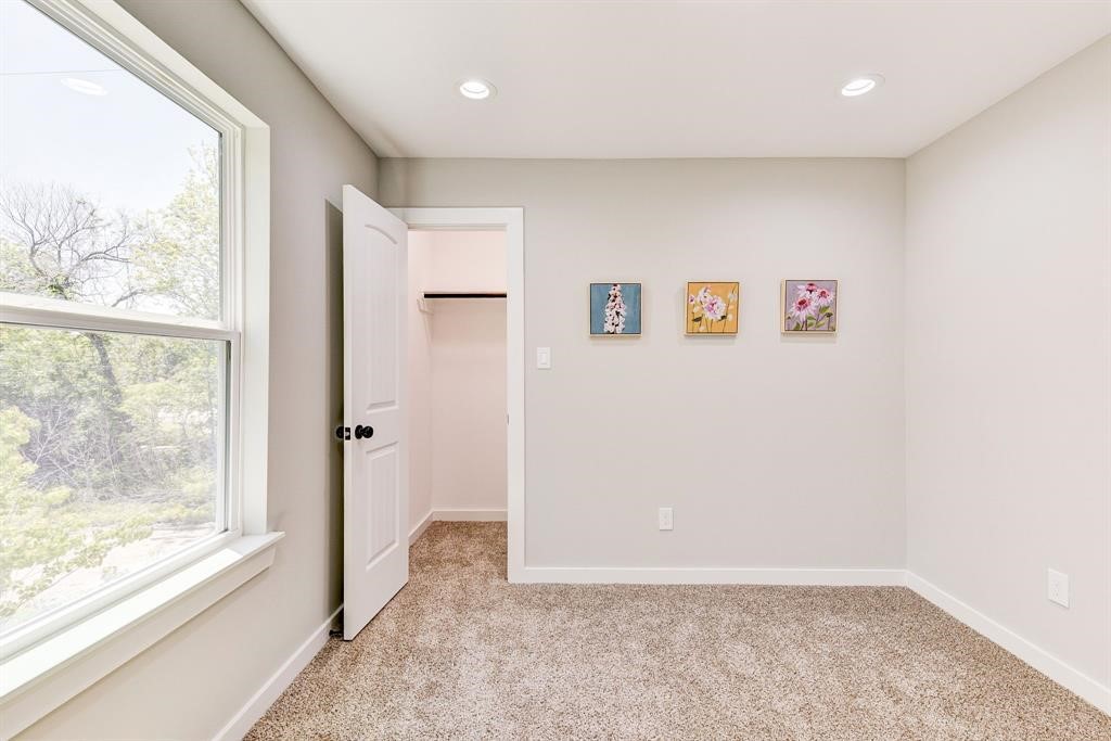 8404 Tate Street, Unit A Houston, TX 77028 - Photo 9 of 10 a view of an empty room with a window