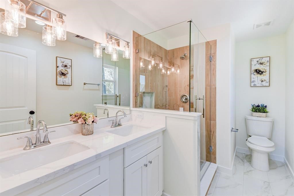 8404 Tate Street, Unit A Houston, TX 77028 - Photo 10 of 10 a bathroom with a sink vanity mirror and toilet