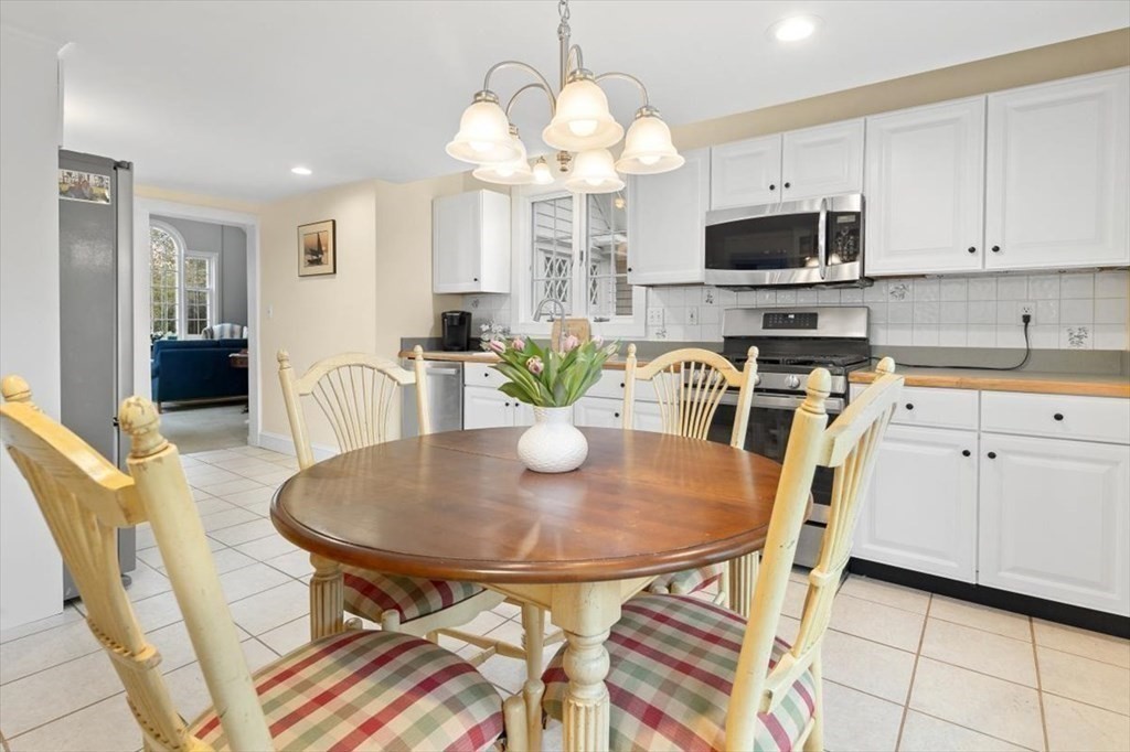 604 First Parish Road Scituate, MA 02066 - Photo 22 of 39 a view of a dining room with furniture and a chandelier