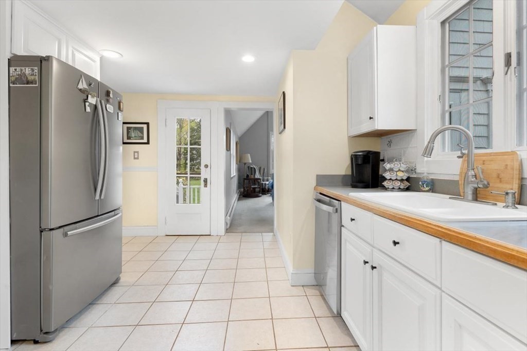 604 First Parish Road Scituate, MA 02066 - Photo 23 of 39 a kitchen with stainless steel appliances a refrigerator sink and cabinets