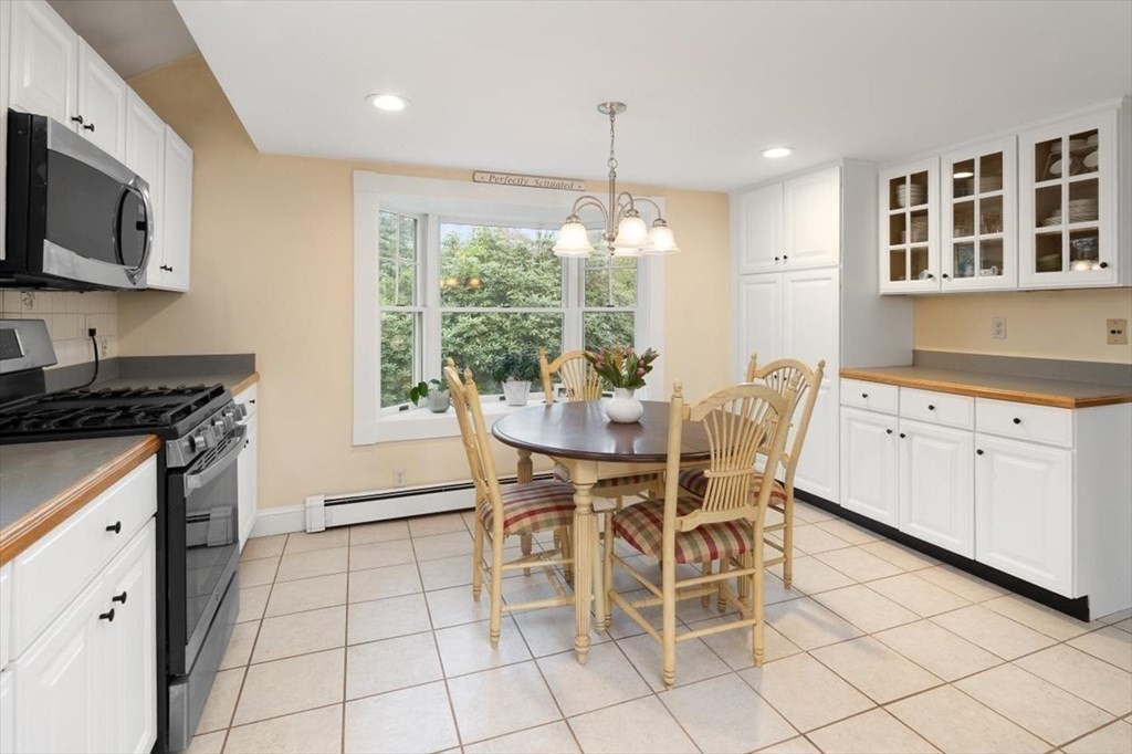 604 First Parish Road Scituate, MA 02066 - Photo 24 of 39 a dining room filled chandelier and kitchen view