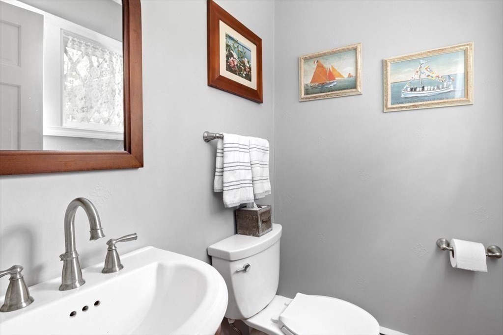 604 First Parish Road Scituate, MA 02066 - Photo 29 of 39 a bathroom with a toilet a sink and mirror