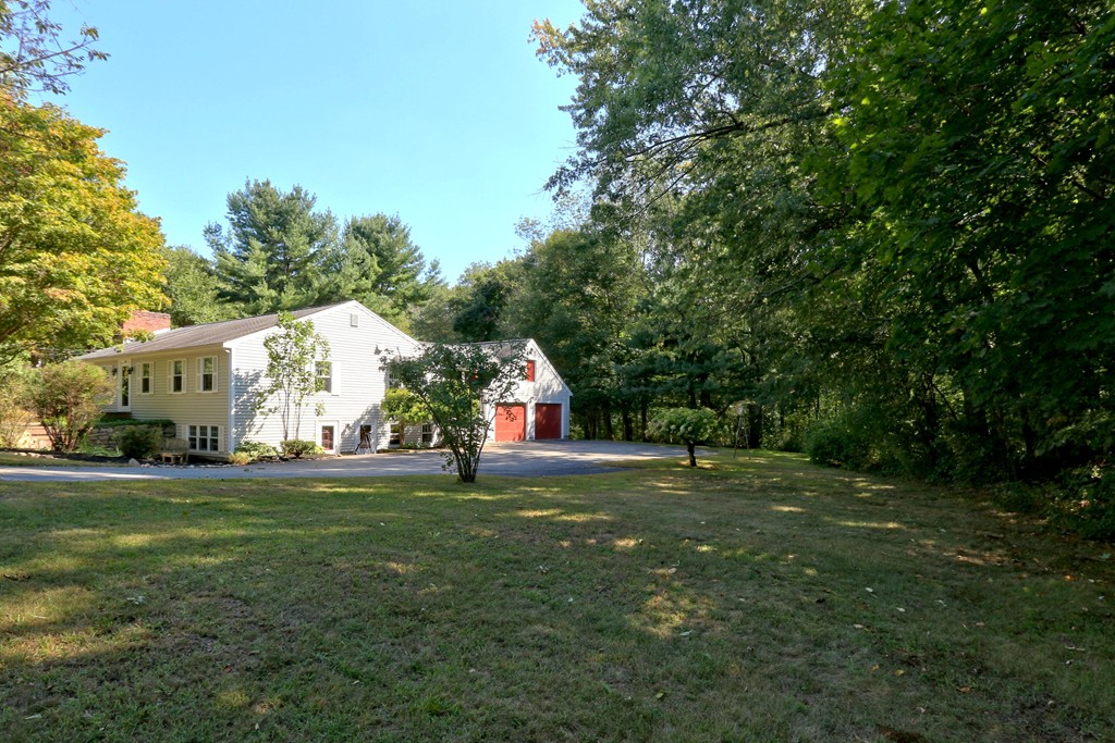 464 Great Road Stow, MA 01775 - Photo 3 of 28 a view of white house with a big yard and large trees