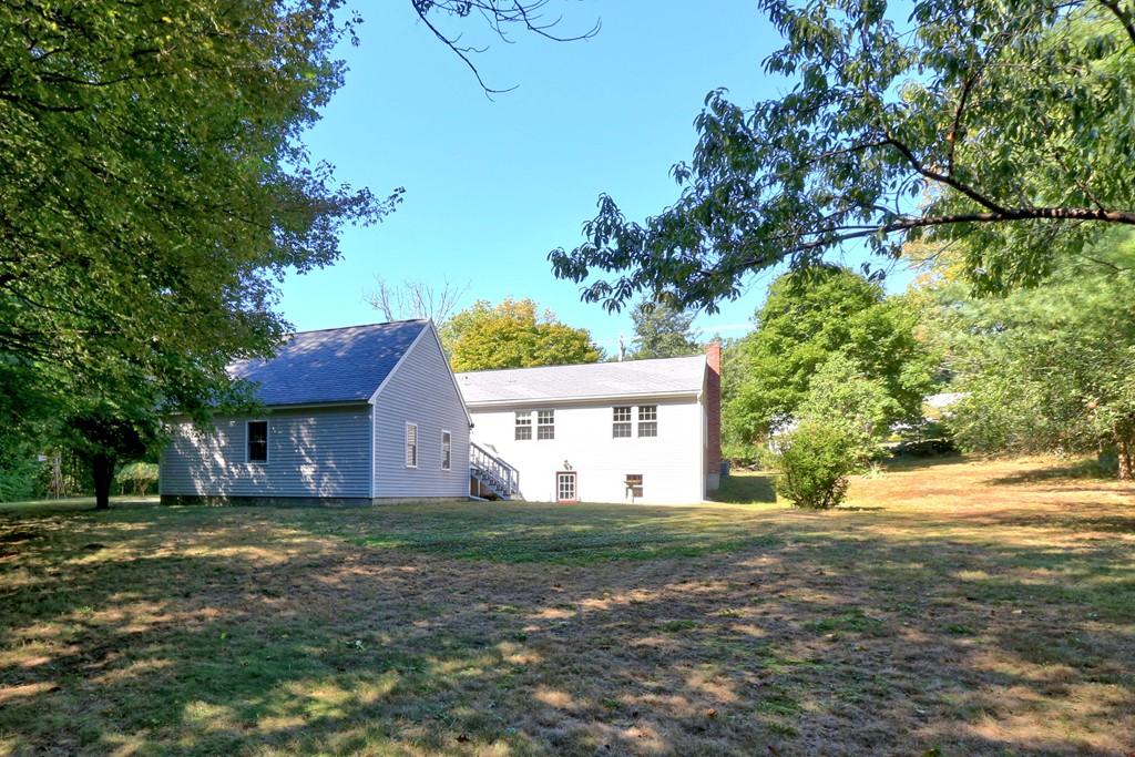 464 Great Road Stow, MA 01775 - Photo 5 of 28 a house that has a tree in front of it