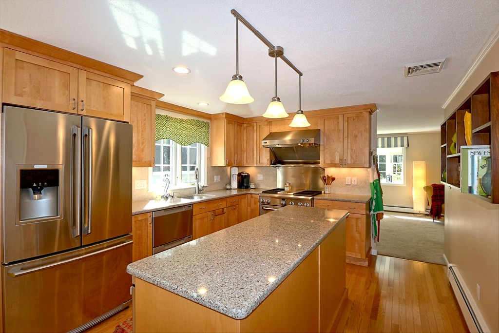 464 Great Road Stow, MA 01775 - Photo 8 of 28 a kitchen with stainless steel appliances granite countertop sink stove refrigerator and cabinets