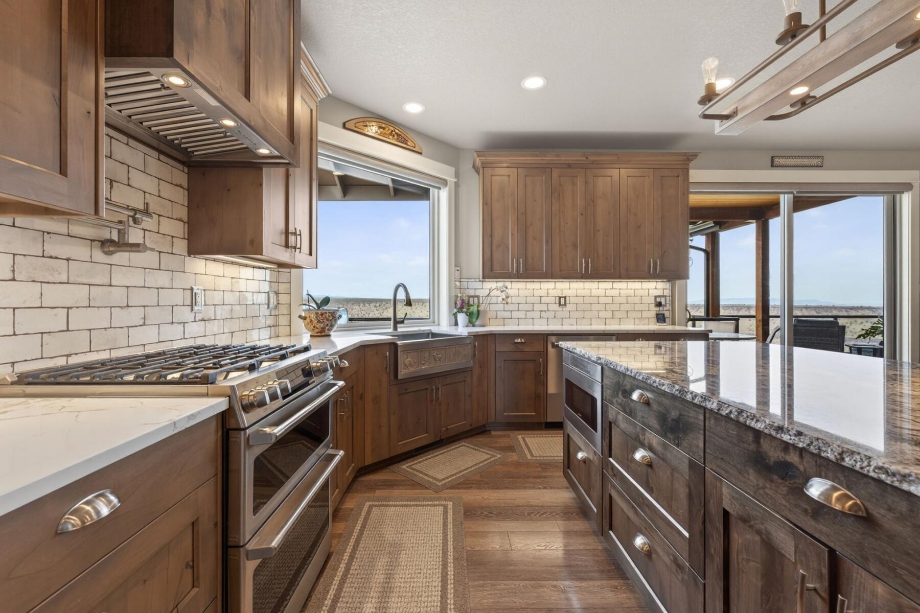 11620 Southwest Pixie Lane Culver, OR 97734 - Photo 12 of 53 a kitchen with stainless steel appliances granite countertop a sink a stove and a refrigerator