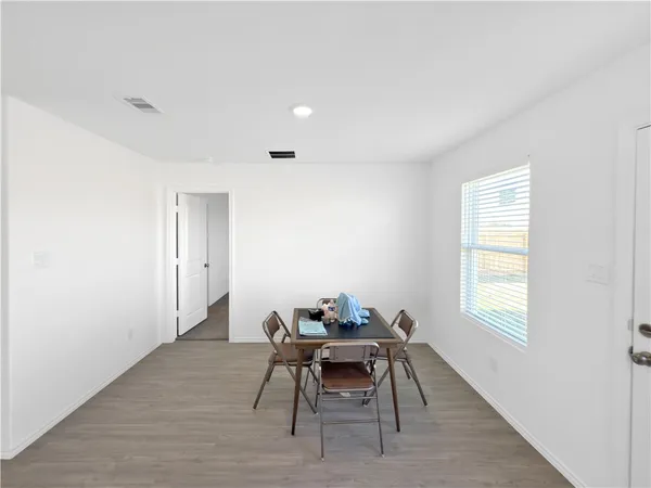 a workspace room with furniture and window
