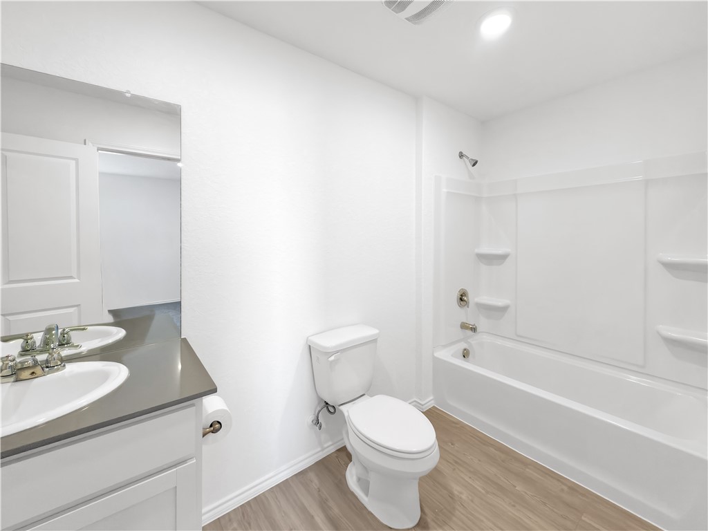 9238 Wilde Way Corpus Christi, TX 78410 - Photo 20 of 26 a bathroom with a sink toilet vanity and bathtub