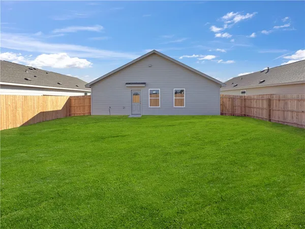 a view of a backyard of the house