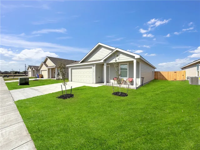 a front view of house with yard and green space
