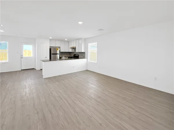 a view of kitchen with granite countertop cabinets and wooden floor
