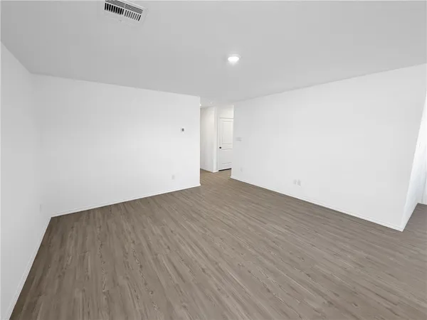 an empty room with wooden floor