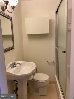 a bathroom with a sink a toilet and mirror